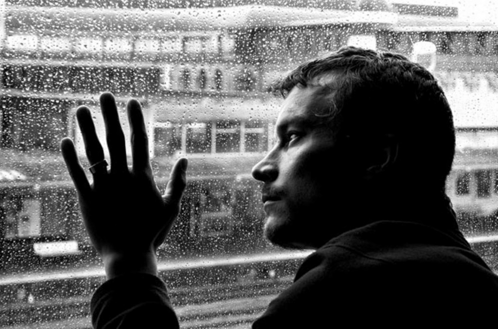 Sad-love-sad-boy-alone-man-alone-in-dark-black-room-looking-out-from-window1
